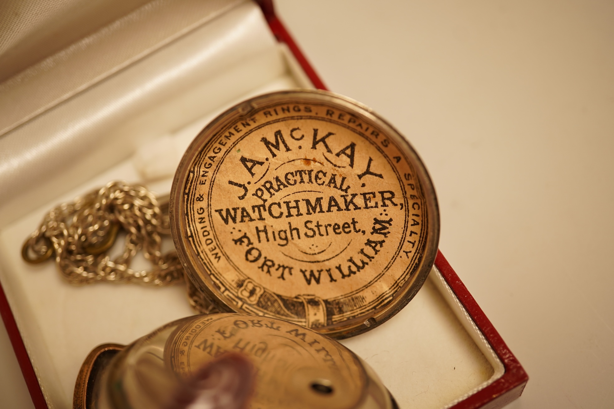 A collection of coins, notes and wrist watches